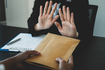 Government officials raise the hand refusing money to take the bribe money from business man the...