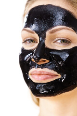 Woman with black peel off mask on face