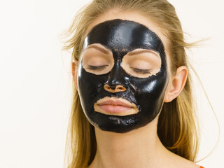 Girl black carbo peel off mask on face