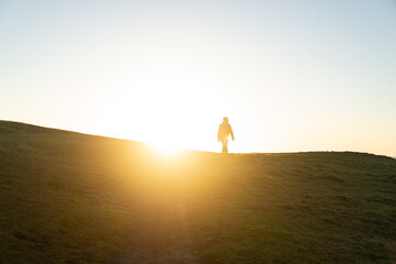 Silhouette of Person against Sunrise on a Hill. Lifestyle and Nature Concept
