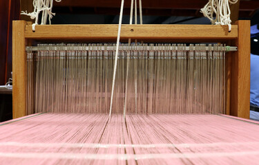 Weaving, making traditional Thailand textiles.