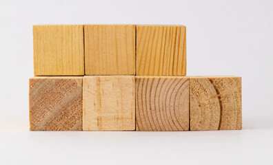 Blank wooden blocks with three on top and four in lower row, for car loan concept.