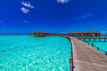 Maldives island, luxury water villas resort and wooden pier. Beautiful sky and ocean lagoon beach background. Summer vacation holiday travel concept. Paradise luxury scene, stunning landscape panorama