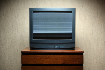 Old TV with clutter on the screen on an old table, vintage design in 80s and 90s style.