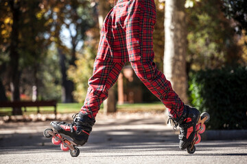 slalom skater legs doing tricks with inline skates and plaid pants