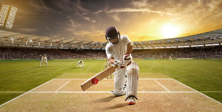 Cricketer batsman hitting a shot during a match on the pitch - Powered by Adobe