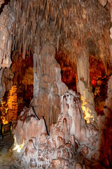 Stalactites and stalagmites in Damlatas cave in Alanya (Turkey), vertical. Mineral formations, icicles and pillars inside the cave