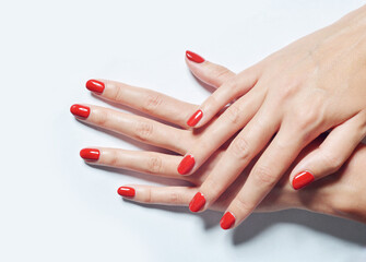 Closeup shot of female hands with red nail polish