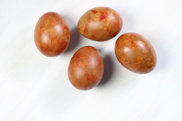 painted brown marble easter eggs on white background