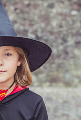 young fair-haired sorceress in mantle and hat