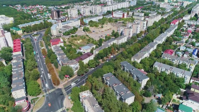 Flying over the road and the roofs of the town
