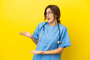 Surgeon doctor woman isolated on yellow background with surprise facial expression
