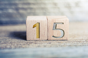 Number 15 Formed By Wooden Blocks On A Board