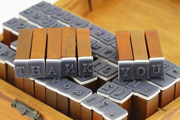 Words thank you made of vintage wooden stamps
