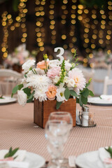 table centerpiece with white and peach rustic floral arrangement in wood box. Rustic wedding table.