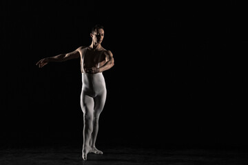 Male ballet dancer on a black background