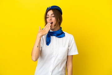 Airplane stewardess woman isolated on yellow background yawning and covering wide open mouth with hand