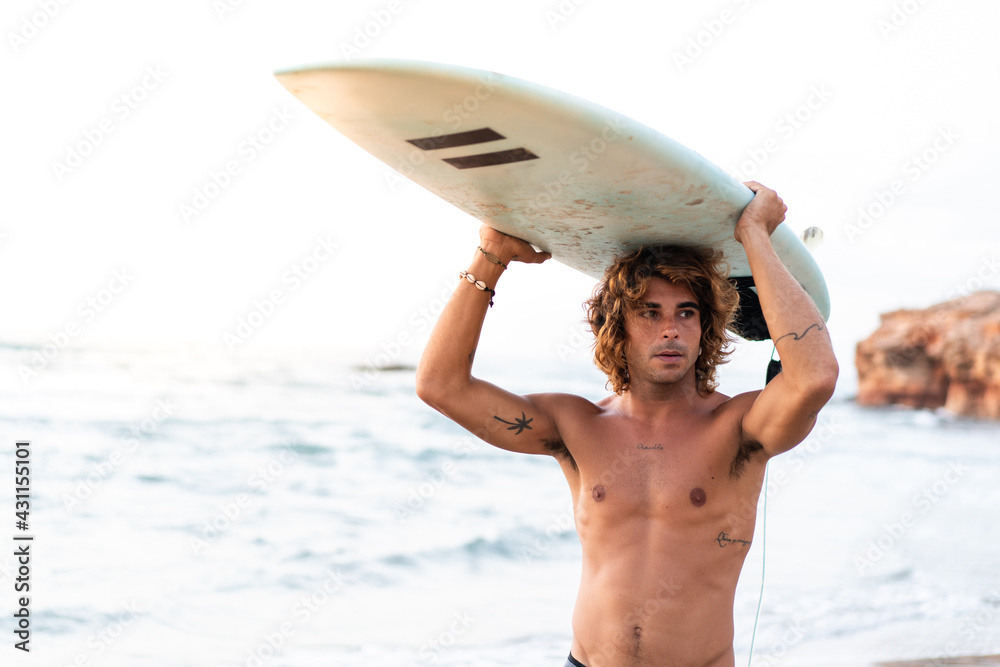 Canvas Prints Young caucasian man get up early to  doing surf at sunrise