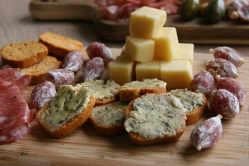 Antipasti dish with bread, garlic butter, cheese and sausage