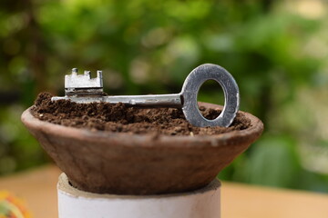 KEY IN FLOWER POT WITH MUD 