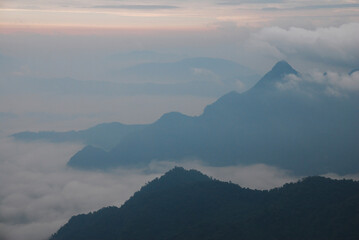 Landscape Nature scene landscape of Fog and Misty in the valley with light of sunrise in the morning of winter season at Phu Chi Fa , Chiangrai , Thailand 
