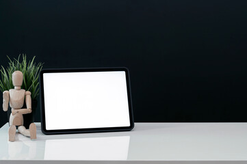 Mockup blank white screen tablet on white top table with copy space.