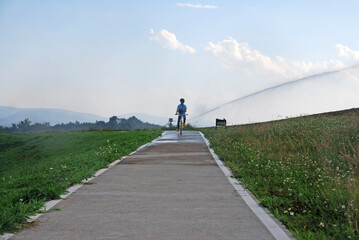 Obraz premium Sport activity ride bicycle on bicycle lane in the parks with Cloud blue sky at singha park , chiang rai , thailand - Travel park and Outdoor 