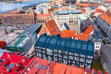Beautiful aerial view of the Riga old town with St. Peters cathedral in the center and the city behind.
