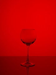 Fototapeta na wymiar Wine glass on a red background