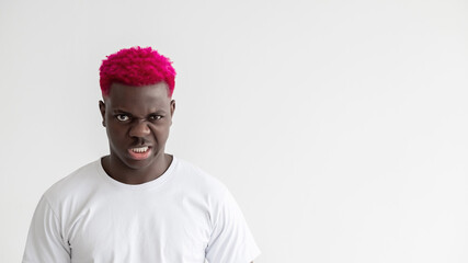 Black lives matter. Aggressive man. Strong power. Social pressure. Advertising background. Angry african guy with bright pink hair white t-shirt isolated light copy space.