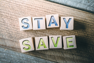 Fototapeta premium Stay Save Written On Wooden Blocks On A Board