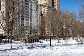 Central Park Winter Landscape with Snow and Old Lincoln Square Skyscrapers in New York City