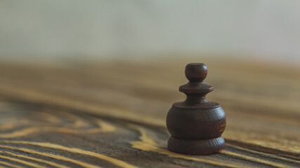 A wooden figure on a chessboard for a strategic game