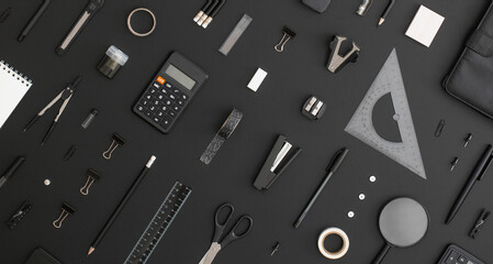 Pattern composition of office and school stationery on black leather background. Back to school