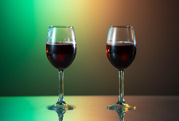 Red wine in the glass on the table. reflected glass. Summer mood