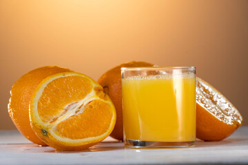 Orange juce, half of orange on the wooden white table. Summer mood. close up shot. raw footage
