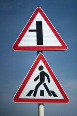 Crosswalk. road sign pedestrian crossing. the road goes to the left. Close up shot