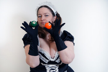 Sexy girl in black gloves holds an orange billiard ball in her hands. The game. Win                ...