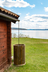 wooden house with rainwater barrel