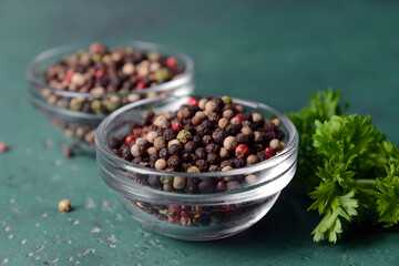Bowls with peppercorns on color background