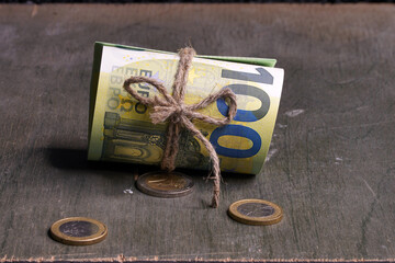 Euro close-up. Money macro. Banknotes are rolled up by a roll with rope. Cash. Banknotes twisted...