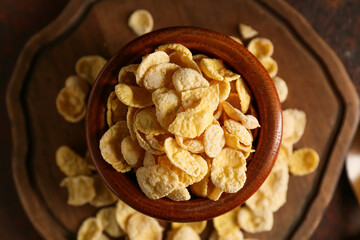 Bowl with tasty cornflakes on grunge background