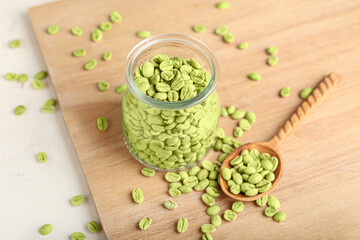 Fototapeta na wymiar Jar with green coffee beans on wooden background