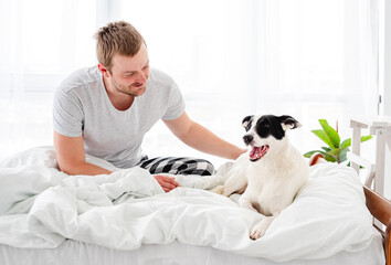 Man with dog in the bed