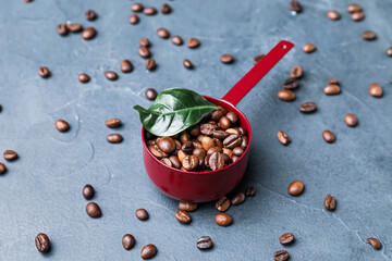Pot with coffee beans on color background