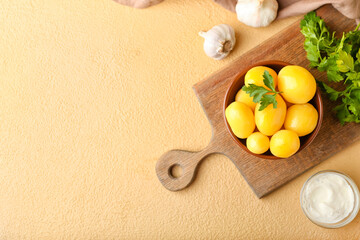 Bowl of tasty boiled potatoes with parsley on color background