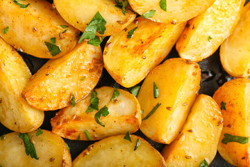 Tasty baked potatoes with parsley, closeup