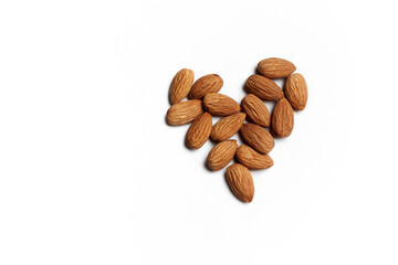 Heart made of almonds on white background