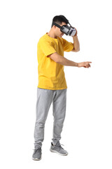 Young man with virtual reality glasses on white background
