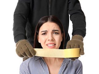 Terrorist putting sticky tape on hostage's mouth against white background